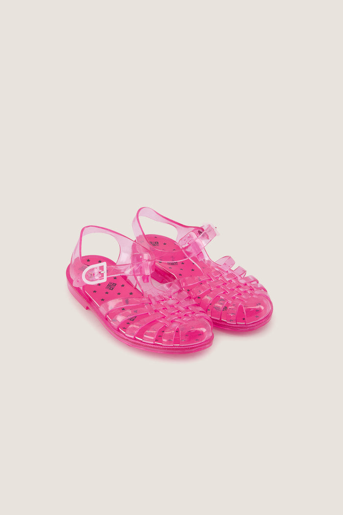 Rose Jelly Meduses Sandals: Classic translucent pink sandals with a caged toe box and ankle strap, offering an effortless, fun style for beach or playground adventures.
