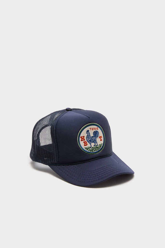 Classic Round Top Trucker Hat with an embroidered rooster patch, combining effortless style and fun for a high-end, versatile accessory by Tuckernuck x Hunter Bell.
