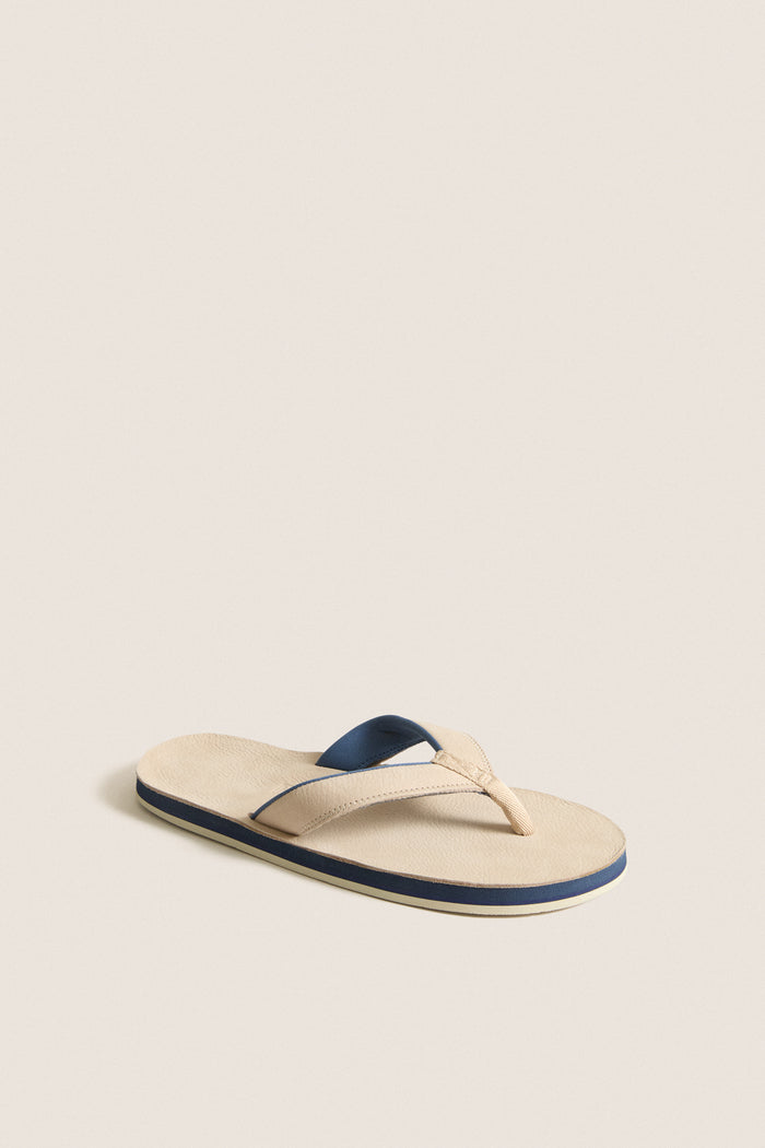 Sand Pier Pebbled Leather Sandal with a classic, minimalist design; features a light beige footbed and stylish Y-shaped strap, perfect for effortless, high-end casual wear.