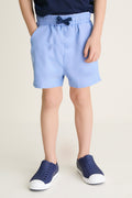 Child wearing Sardinia Sky Le Club Short, featuring classic light blue design with bow detail, paired with navy top and slip-on shoes for an effortless, high-end look.