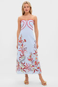Woman models the Seascape Hayden Midi Dress, a classic sky-blue strapless piece with effortless red piping, floral print, and high-end gold sandals, embodying fun elegance.