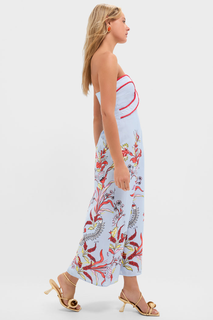 Seascape Hayden Midi Dress: A woman in a strapless, floral A-line dress with red piping, styled with orange earrings and gold heels, exuding classic, effortless elegance.