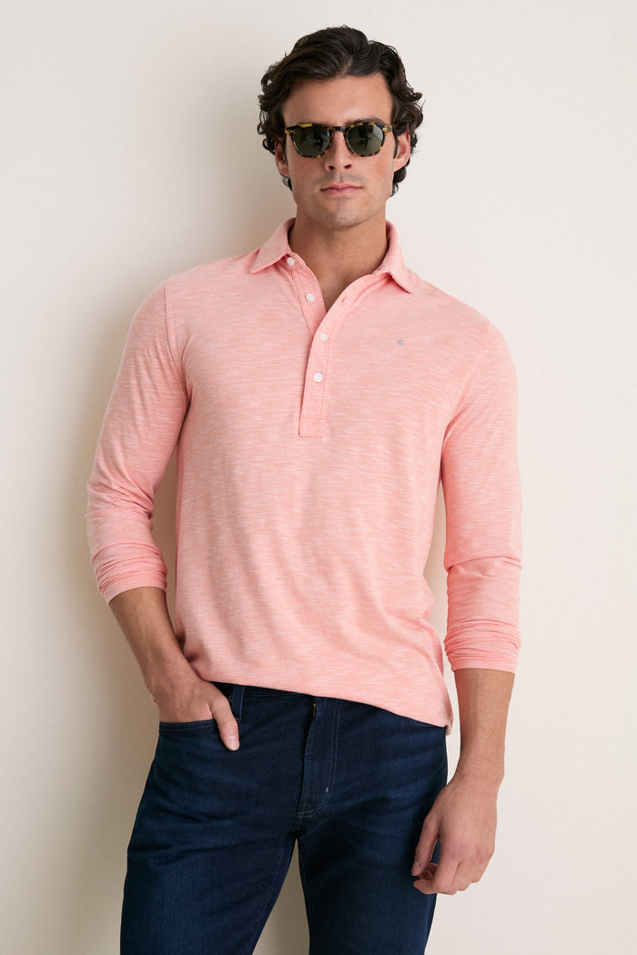 Young man in tortoiseshell sunglasses wearing a classic, effortless Shell Phone Brrr Long Sleeve Range Polo, showcasing its high-end, fun design and cooling technology.