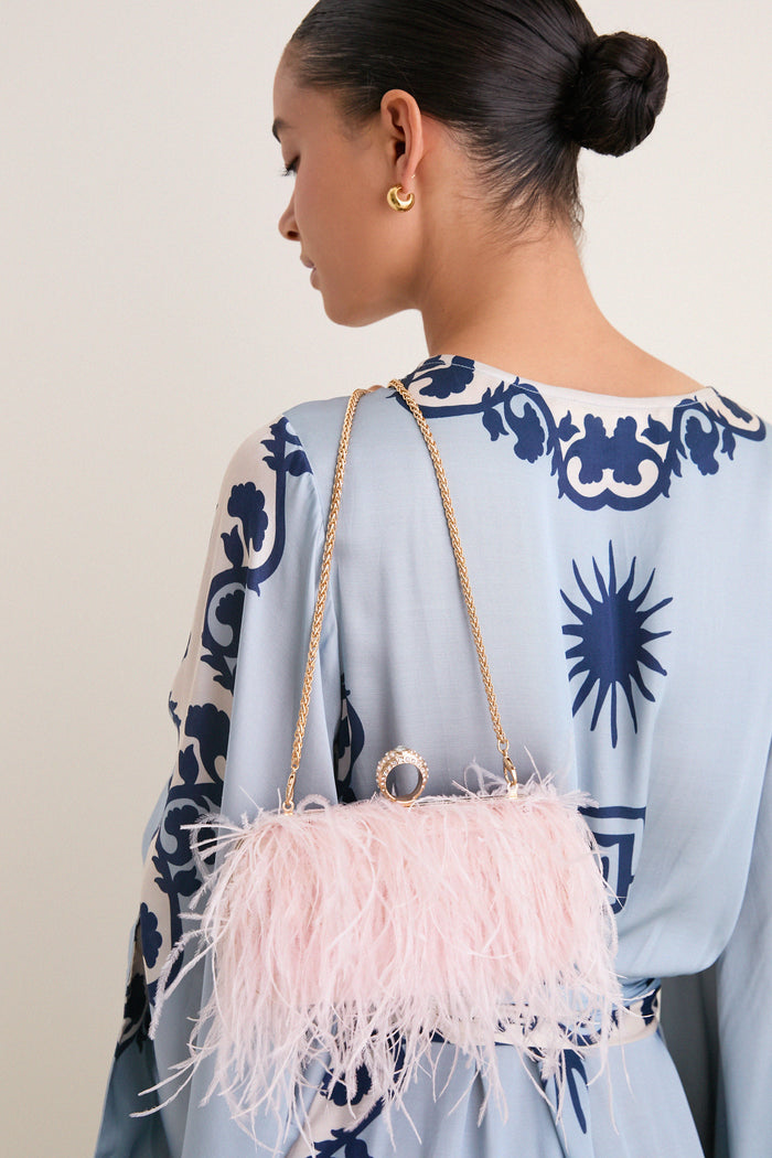Soft Pink Harlow Bag features a pastel-pink feather trim, classic gold chain, and rhinestone ring handle, embodying effortless sophistication for high-end, fun evenings out.