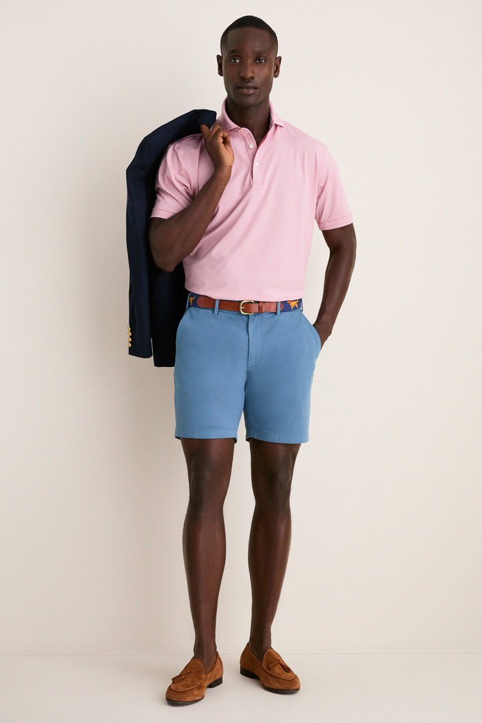 Man in classic Storm Andrews Flat-Front Shorts, showcasing effortless, high-end style with a navy blazer and brown loafers, epitomizing fun, confident seasonal fashion.
