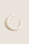 Swirl Chalk Crescent Cuff: A classic, high-end ear cuff with a glossy cream enamel finish and silver-tone accents, offering an effortless, fun touch to any outfit.