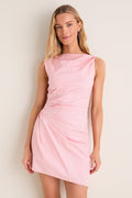 Woman in a classic, pink Tulip Callie Mini Dress with a high neckline and asymmetrical hem, showcasing effortless style. Perfect for fun, high-end occasions.