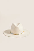 White and Multi Charlotte Traveler Hat, a classic wide-brimmed straw fedora with playful multicolored bead accents, offering effortless sun protection and high-end style.