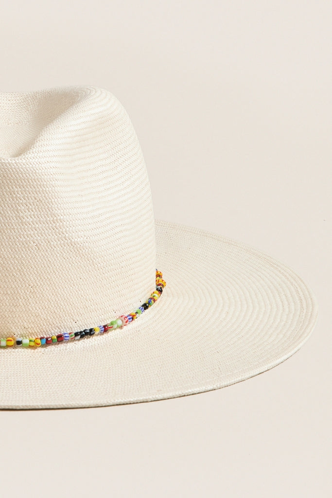 Classic and effortless, the White and Multi Charlotte Traveler Hat features a wide brim, pinched crown, and fun, high-end beaded trim, perfect for sunny adventures.