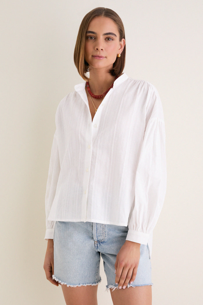 White Shadow Stripe Juliette Button Down exudes classic elegance with its flowy silhouette and subtle stripes, perfect for an effortless, high-end, and fun look.