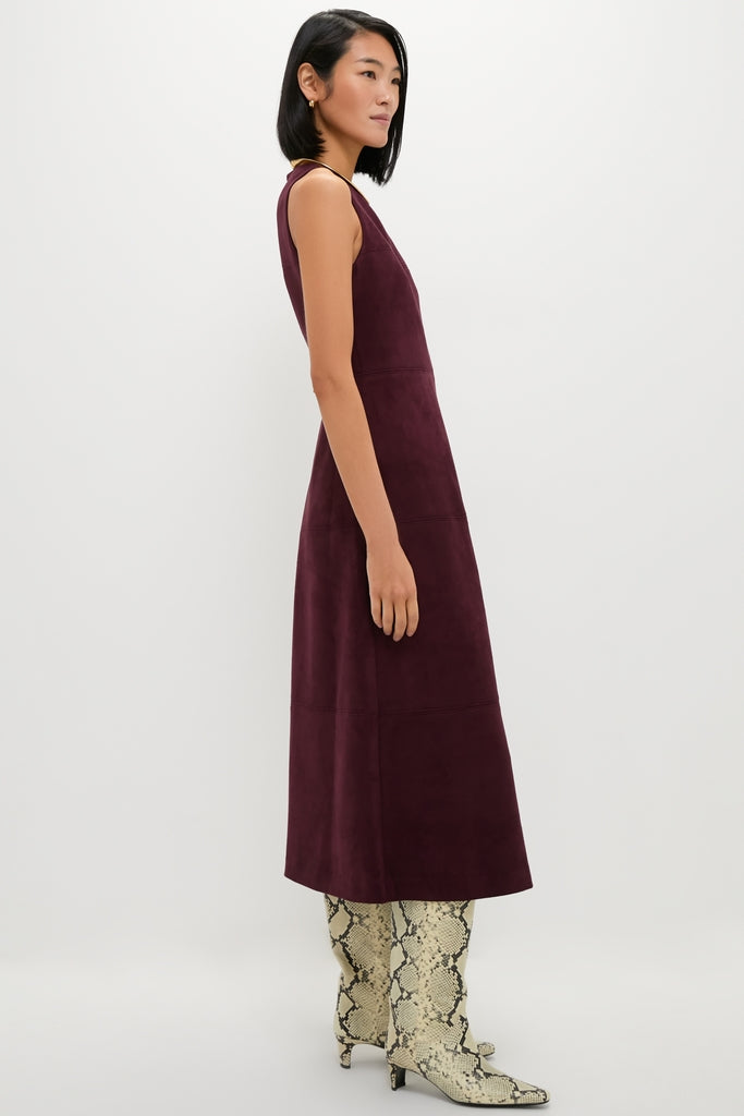 Model in profile wearing the Winetasting Vegan Suede Manon Dress, a classic, high-end A-line midi with panel details, styled with fun, effortless snakeskin print boots.