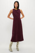 Winetasting Vegan Suede Manon Dress features a classic column silhouette with panel detailing, styled effortlessly with snake-skin boots for a high-end, fun look.