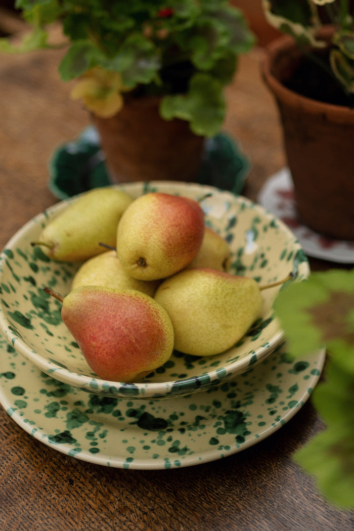 Yellow and Verde Large Splatter Bowl with ripe pears, showcasing a classic, high-end ceramic piece on a wooden table for effortless and fun dining occasions.