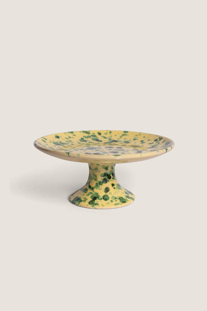 Yellow and Verde Splatter Cake Stand with a classic, hand-painted speckled design on ceramic; effortlessly blends fun and high-end aesthetics, perfect for serving treats.