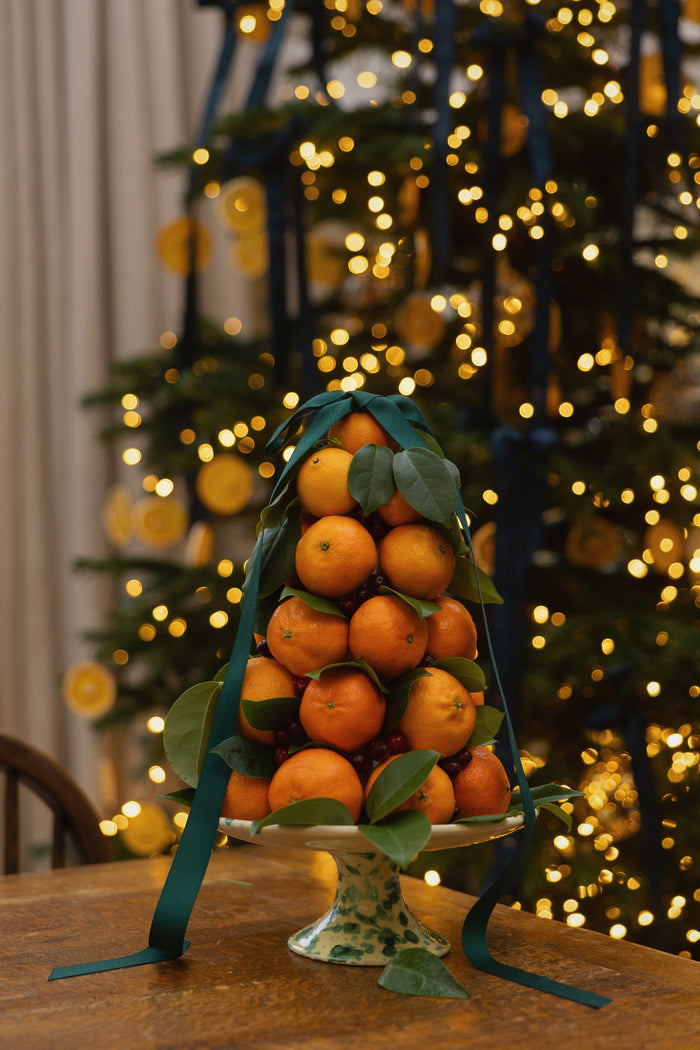 Classic festive display on a high-end Yellow and Verde Splatter Cake Stand, featuring oranges, leaves, and berries, embodying effortless elegance and fun. Crafted in Italy, dishwasher safe.